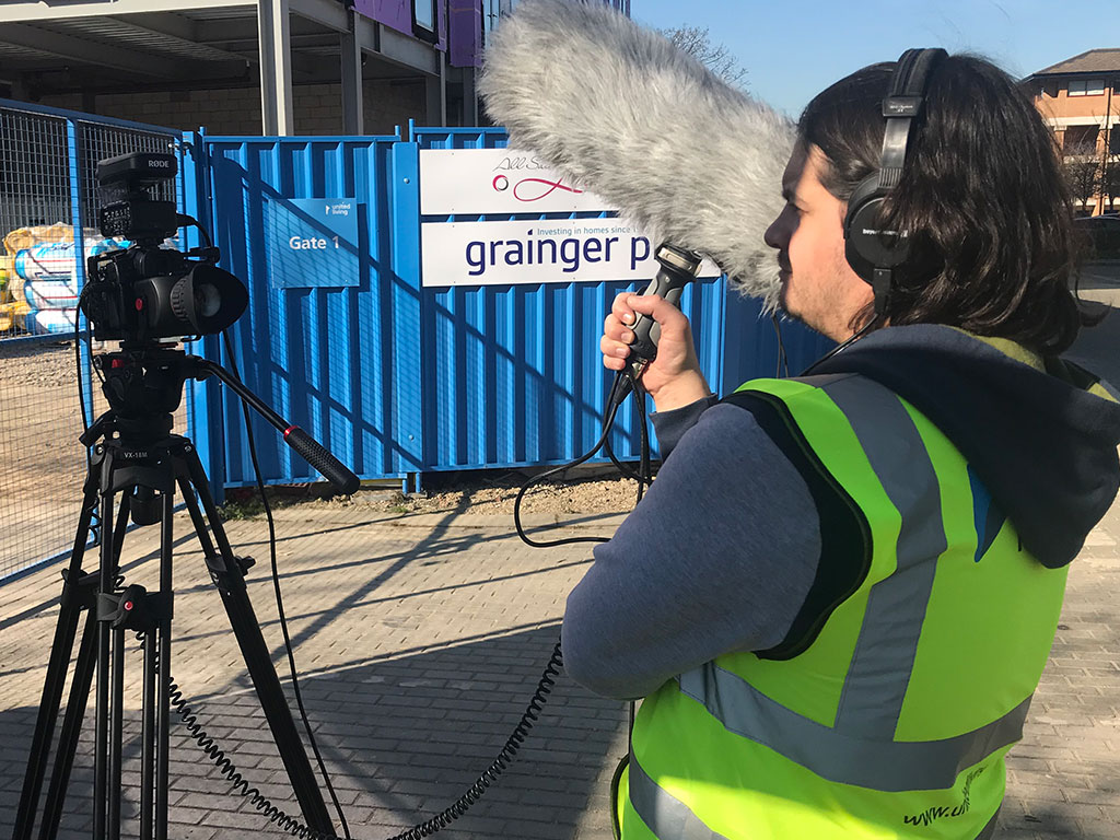 Sound engineer capturing audio for a construction video