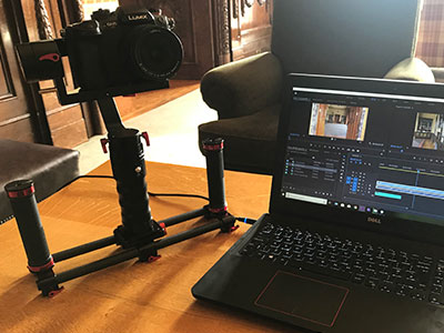 camera on a gimbal and a laptop being used to film and edit an event highlights video