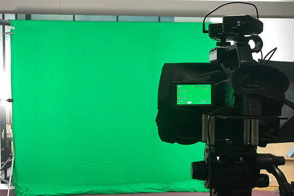 green screen with camera and auto in foreground