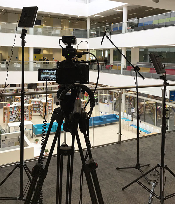 Camera, lights and audio set up ready to film in an office setting